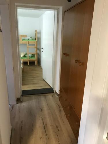an empty hallway with a door and a mirror at Family escape apartment free parking in Belgrade