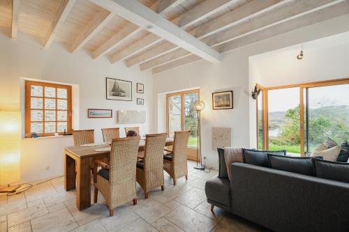 a dining room with a table and chairs at Maison Plage Verger Cancale in Cancale