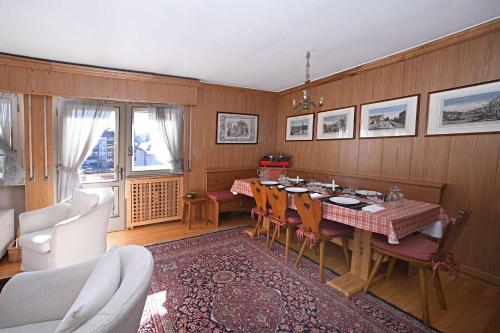 a dining room with a table and chairs at Homeby, Casa Due Vette in Cortina dʼAmpezzo