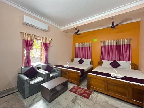 Ένα ή περισσότερα κρεβάτια σε δωμάτιο στο Kristi Guest House, Shantiniketan