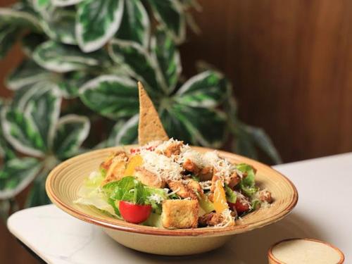 a plate of food with a salad on a table at فندق المدينة القديمة Old Town Hotel in Nizwa