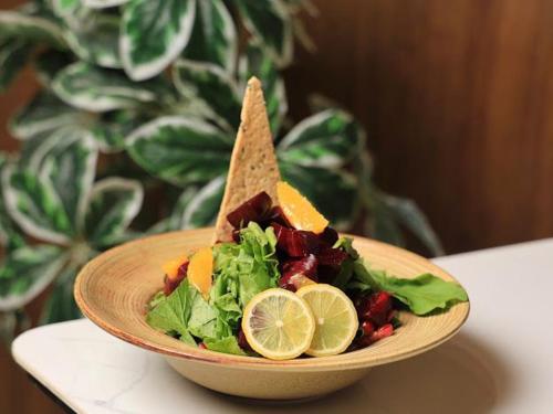 a plate of food with a salad and a sandwich at فندق المدينة القديمة Old Town Hotel in Nizwa