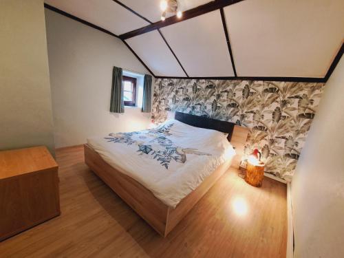 a bedroom with a large bed in a room at Gîte al fontaine in La Roche-en-Ardenne