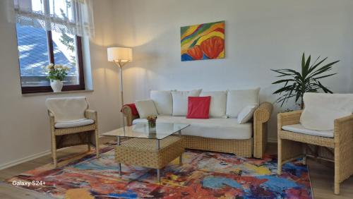 a living room with a couch and two chairs and a table at Markt 9 Appartements Oberwiesenthal in Kurort Oberwiesenthal