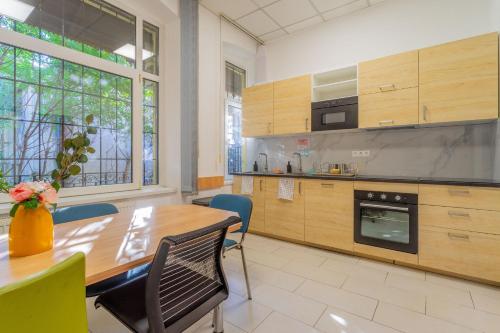 a large kitchen with a wooden table and chairs at Grassalkovich Residence in Budapest