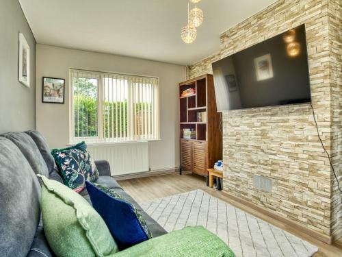 a living room with a couch and a stone fireplace at Dog-Friendly Haven Parking Prime Location - Pass the Keys in Lincoln