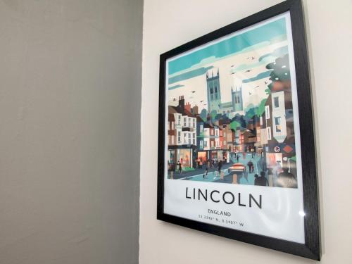a framed painting of a city on a wall at Dog-Friendly Haven Parking Prime Location - Pass the Keys in Lincoln
