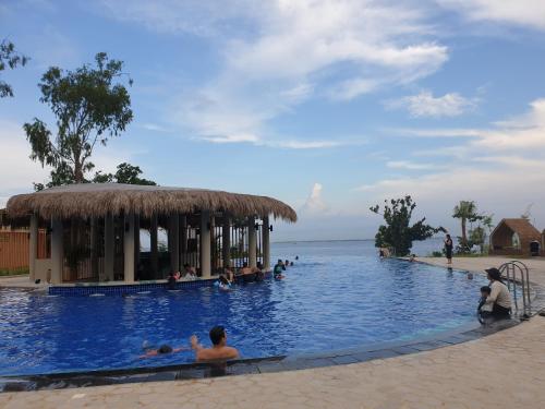 a large swimming pool with people in the water at One Pacific Residence Condominium Tower C-16N in Mactan