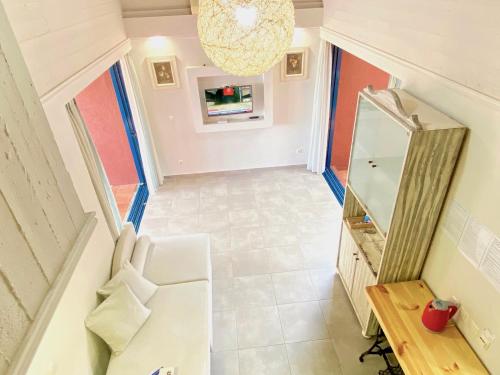 an attic hallway with a mirror and a dressing table at Barbati Alpha MiniVilla by DadoVillas in Barbati