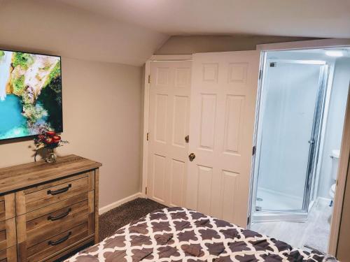 a bedroom with a bed and a sliding glass door at Nice house with private parking, king bed fenced yard in West Seneca