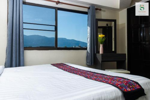 a bedroom with a bed with a large window at Sripoom House 1 in Chiang Mai