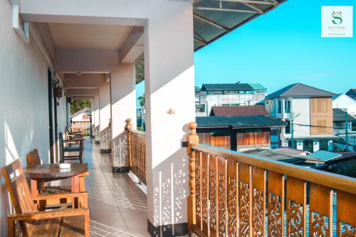 a balcony of a house with a table and chairs at Sripoom House 1 in Chiang Mai