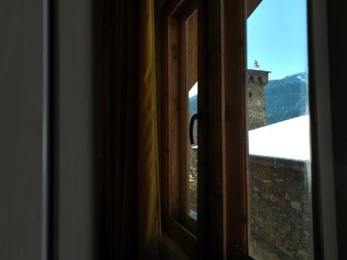 a window with a view of a mountain view at Guesthouse Lanchvali in Mestia