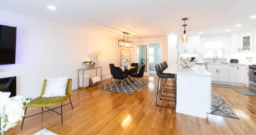 a kitchen and living room with a table and chairs at The Charles-South Shore in Randolph