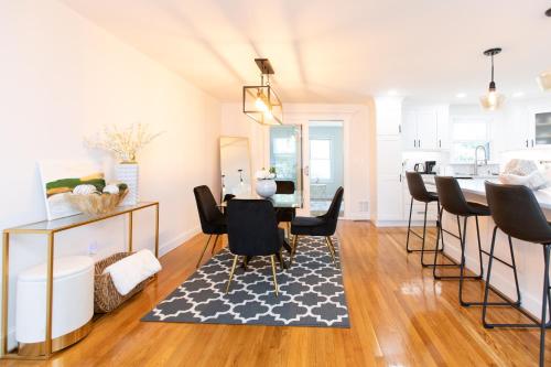 a kitchen and dining room with a table and chairs at The Charles-South Shore in Randolph
