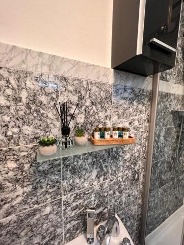 a bathroom with a sink and some plants on a wall at Villa GiNa Apartement in Albbruck