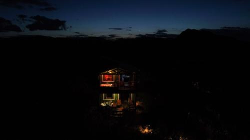 a small house at night with its lights on at Vila Verde in Palmeiras