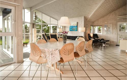 a dining room with a table and chairs at Holiday Home Skippervej in Blåvand