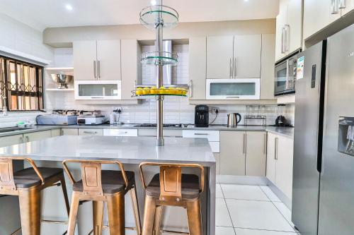 a kitchen with a table and four chairs at Lefatshe La Rona Guesthouse in Springs