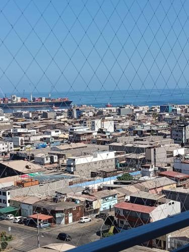 a view of a city with buildings and the ocean at Departamento familiar Iquique in Iquique
