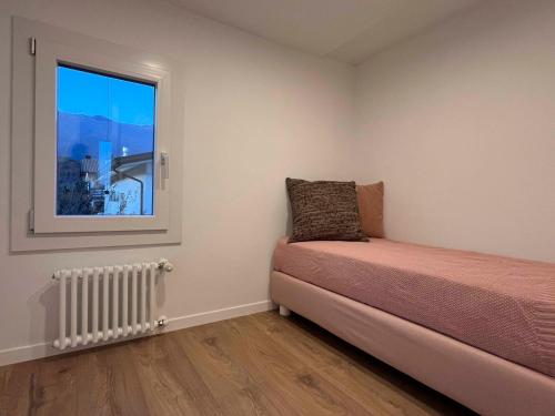 a bedroom with a bed and a window at CasaTitti Polcenigo in San Giovanni