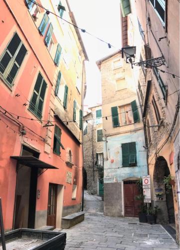 an alley in an old city with buildings at La Casa di Colombetta in Badalucco