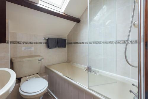 a bathroom with a toilet and a shower and a sink at Beech Cottage - Spacious Cottage with Pool Near Coastal Trails in HAW