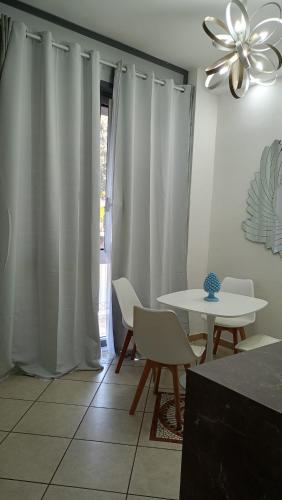 a dining room with a table and chairs and a ceiling fan at Costa Costa Rooms in Sant'Egidio del Monte Albino