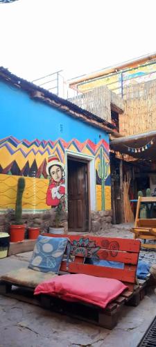 a building with a mural on the side of it at Giramundo Hostel in Humahuaca