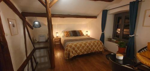 a bedroom with a bed with two lamps and a staircase at Adorable maison cévenole in Bez-et-Esparon