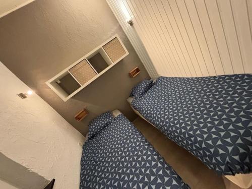 a small bedroom with a bed and a couch at Entre nous4 in Virton