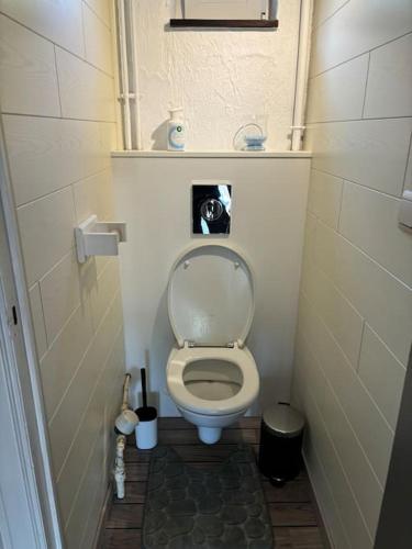a small bathroom with a toilet with the lid up at Entre nous4 in Virton
