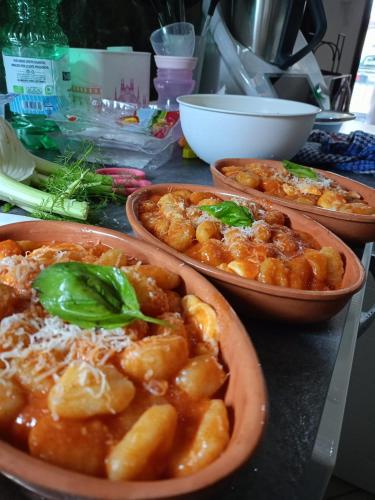 three bowls of food sitting on a table at Costa Costa Rooms in Sant'Egidio del Monte Albino