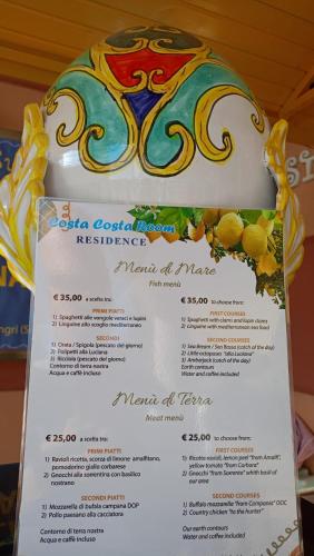 a menu for a restaurant with a cake on top at Costa Costa Rooms in Sant'Egidio del Monte Albino