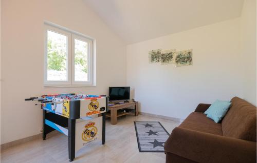 a living room with a couch and a table at Beautiful Home In Kamen Most in Kamenmost