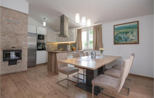 a kitchen and dining room with a wooden table and chairs at Beautiful Home In Kamen Most in Kamenmost