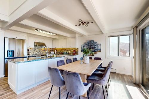 a kitchen with a large wooden table and chairs at Rita's-by-the-Sea in Moss Landing