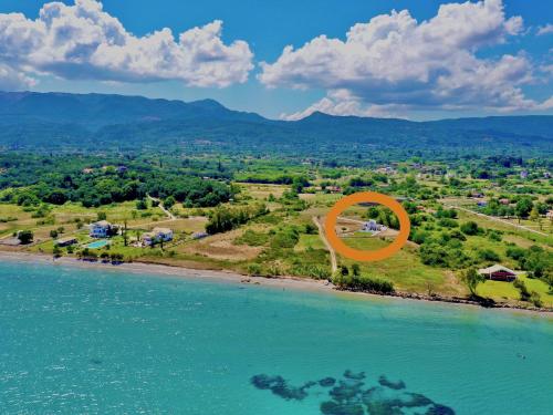 an orange circle on a beach next to the water at Danune Luxury Beachfront Villa with private pool by DadoVillas in Astrakeri