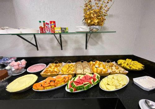 a table with many different types of food on it at Brasília Park Hotel in Brasilia