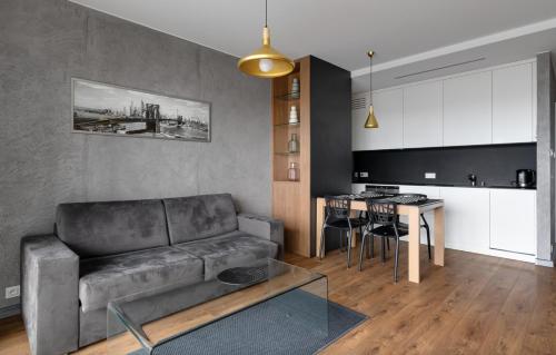 a living room with a couch and a table at Poznań Apartments Towarowa in Poznań