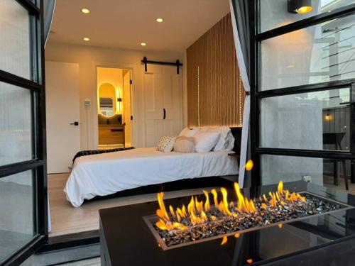 a bedroom with a bed and a fire place at Ventana Vista, Ocean View in San Diego