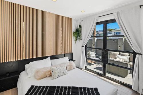 a bedroom with a bed and a large window at Ventana Vista, Ocean View in San Diego
