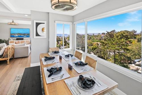 a dining room with a table and a large window at Ventana Vista, Ocean View in San Diego