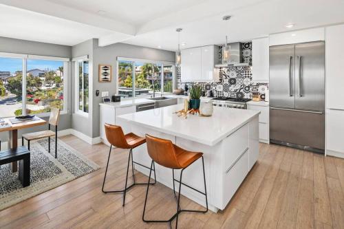 a kitchen with a large white island in a room at Ventana Vista, Ocean View in San Diego