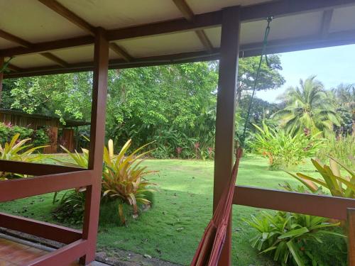 a view from the porch of a house with a hammock at KintsugiKanjiatCocles in Cocles