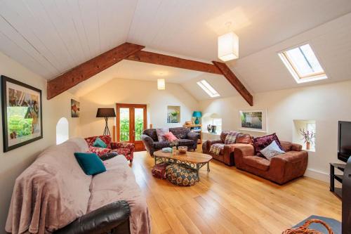 a living room with a couch and a table at The Coach House 5 star property in Inistioge