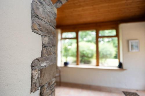 a brick wall with windows in a room at The Coach House 5 star property in Inistioge