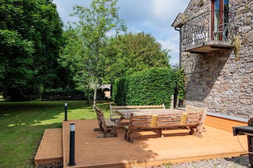a wooden deck with a table and two chairs at The Coach House 5 star property in Inistioge