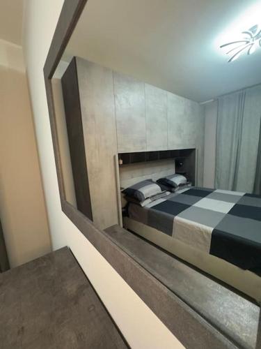 a bedroom with a bed with a large mirror at GC Hejme Locazione Turistica in Lunghezza