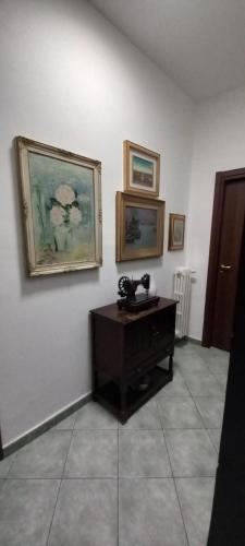 a room with a telephone and paintings on the wall at Ca'Nostra in Bagnolo Piemonte